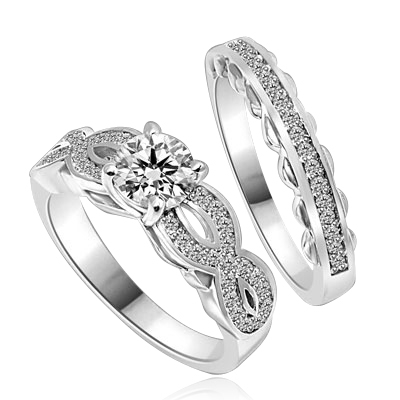 Wedding Set- 1.0 Ct. Round Brilliant Diamond Essence in center with Melee set in intervening design on either side and wedding band with delicately set Melee. 1.35 Cts. T.W. set in 14K Solid White Gold.