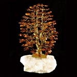 The leaves of this bonsai style tree are made with real polished amber stones attached to branches and trunk of twisted brass wire.  The tree sits atop a piece of the finest Polish marble called "Marianna".