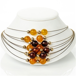 Eight beautiful strands of round amber beads in three shades on silver wire.  Each amber bead is separated by a silver sphere.