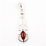 Baltic amber with sterling silver detail. Our musical instrument is approx 2" x .5".