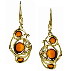 Stylish and unique.  Cherry amber in a setting of gold vermeil wire and studded with a cubic zirconia.