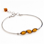 This sterling silver bracelet features a gorgeous row of honey amber. Size is 7.5" diameter with a 1" extender.