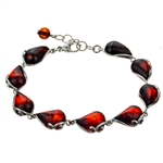 9 elegant drops of cherry amber each set in sterling silver . Bracelet is 8" long and adjustable smaller.