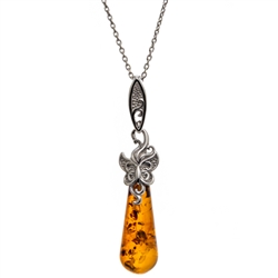 Sterling silver butterfly resting on a beautiful honey amber cabochon drop. Pendant size is approx. 2" x 0.4".