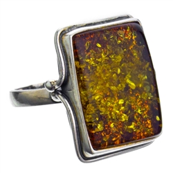 A beautiful amber cabochon framed in a classic sterling silver frame. Size is approx 1" x .75".