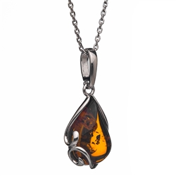 A beautiful honey amber cabochon framed in an open back sterling silver frame. Pendant size is approx. .75" x .5".