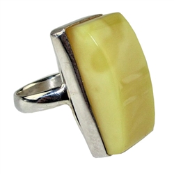 A beautiful custard color amber cabochon framed in a classic sterling silver frame. Size is approx 1" x .5".