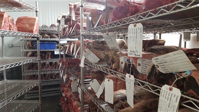 Steak dry-aging in a temperature and humidity-controlled room